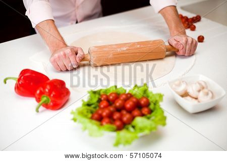 Preparing a dough for italian pizza close up