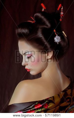 Beautiful geisha in kimono with samurai sword