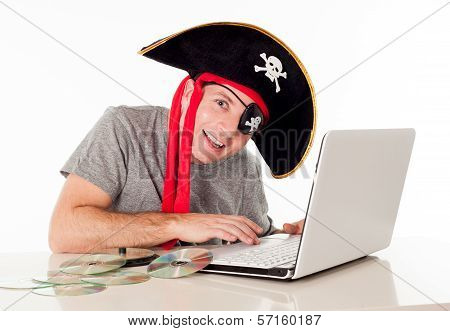 Man In Pirate Hat Downloading Music On A Laptop