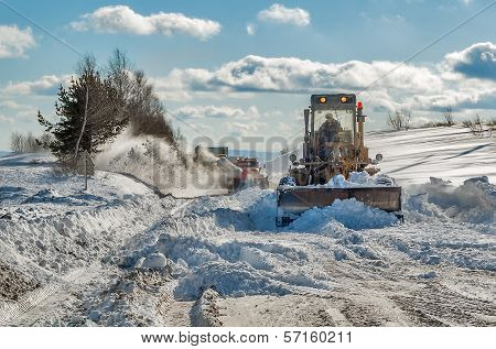 truck cleaning road in winter