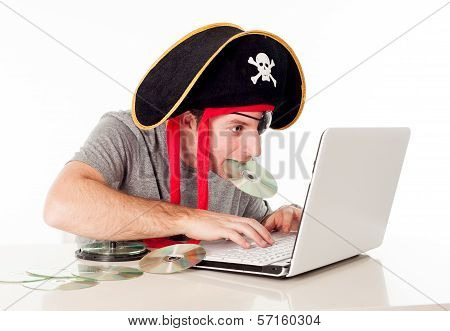 Man In Pirate Hat Downloading Music On A Laptop