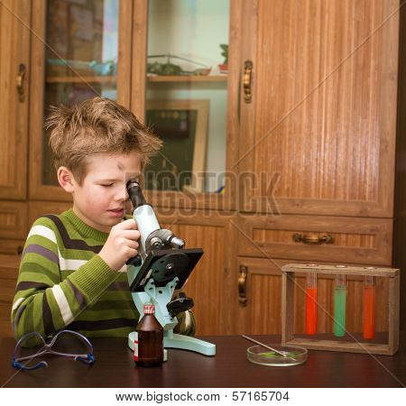 Little boy making science experiments. Education.
