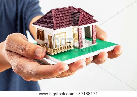 Man Holding House Model