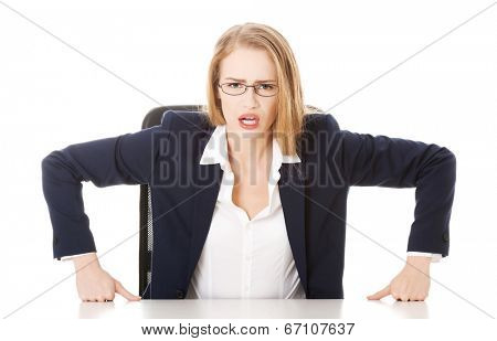 Attractive business woman by the table, bossy behaviour. Isolated on white.