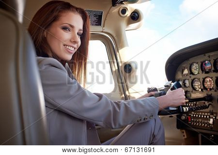 Female pilot preparing for a flight in a light aircraft 