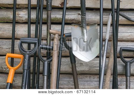 shovel near a wooden wall