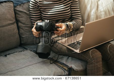 Closeup On Young Woman With Laptop Using Modern Dslr Photo Camera