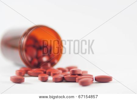 Brown Tablet On Medicine Bottle Background