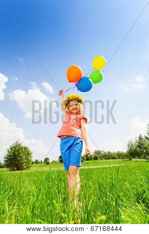 Small girl with colorful balloons wearing circlet