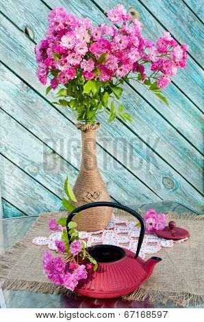 still life bouquet with roses and tea pot