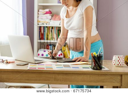 Pregnant woman working from home