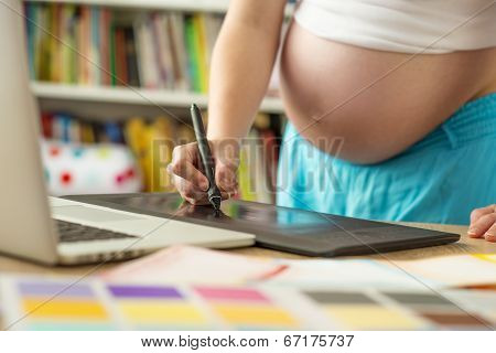 Pregnant woman working from home