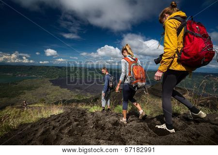 Group of hikers descending on friable ground in the caldera of volcano of Batur. Bali, Indonesia