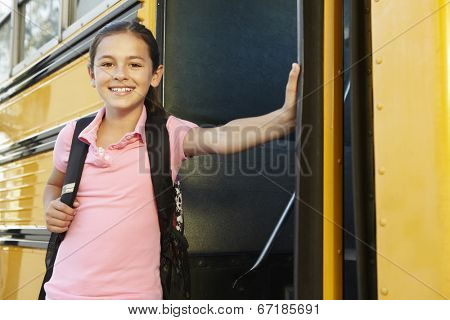 Pre teen girl getting on school bus