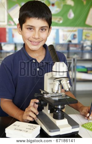 Boy in science class with microscope