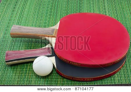 Two Table Tennis Rackets On Green Surface