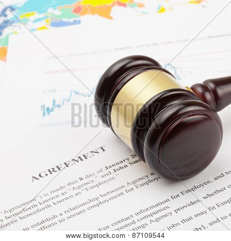 Wooden Judge's Gavel Over Agreement Documents And World Map