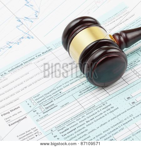 Wooden Judge's Gavel Over Tax Form