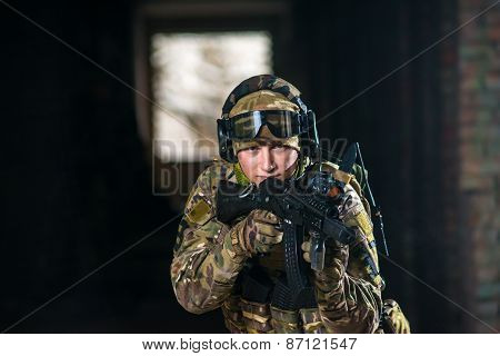 Airsoft strikeball player in uniform. Soldier full gear. Man with a gun is playing airsoft