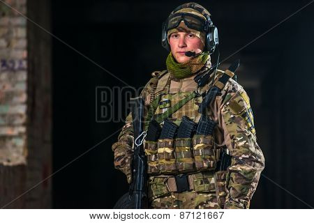Airsoft strikeball player in uniform. Soldier full gear. Man with a gun is playing airsoft