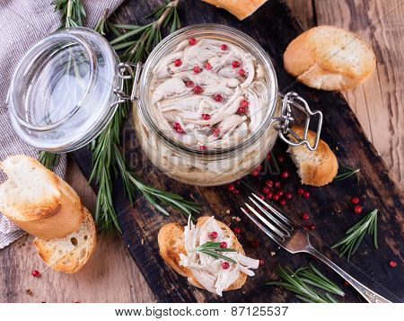 Chicken Pate In Glass Jar And Toast Bread On Rustic Kitchen Board