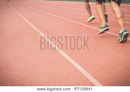 Running Track With Blur Of Runner Feet In Stadium