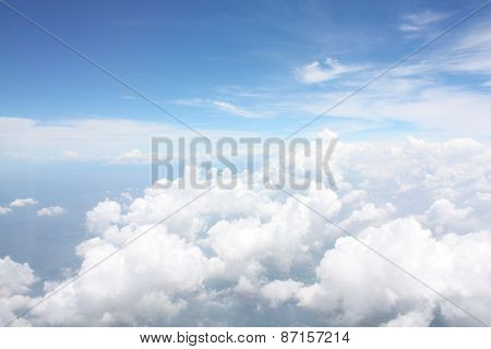Sky view and white clouds layers looking from airplane window