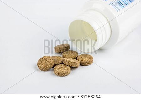 Brown Pills And Plastic Jar