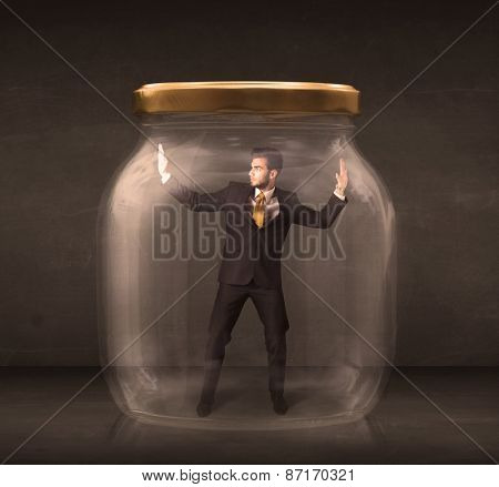 Businessman shut into a glass jar concept on background