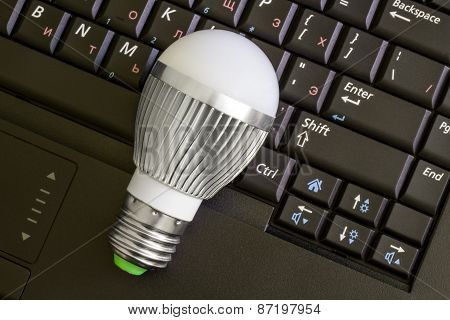 Close up Led Bulb at the keyboard background.