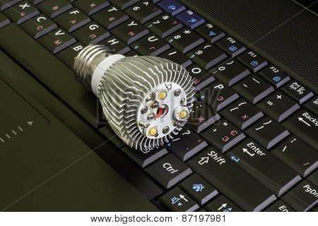 Close up disassembled Led Bulb at the keyboard background.Horizontal.