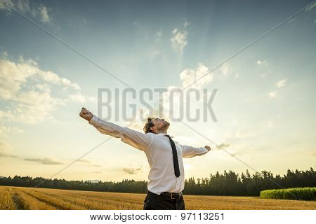 Thankful Businessman With Open Arms At The Field