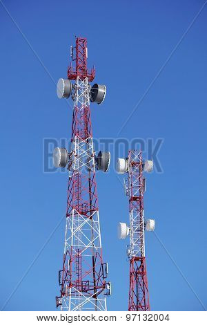 Towers Of Mobile Operators On A Background Of Blue Sky