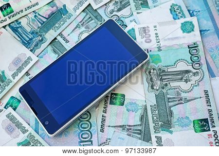 Mobile phone smartphone and money on Russian banknotes