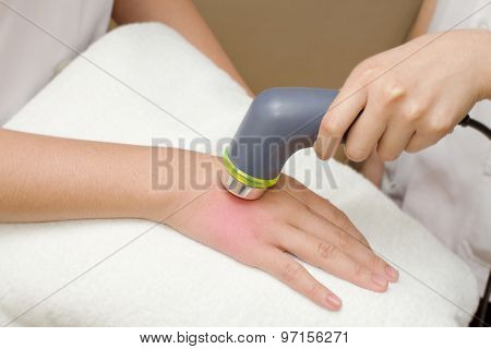 Physical Therapist Using Ultrasound Probe On Woman Patient 's Hand For Release Pain