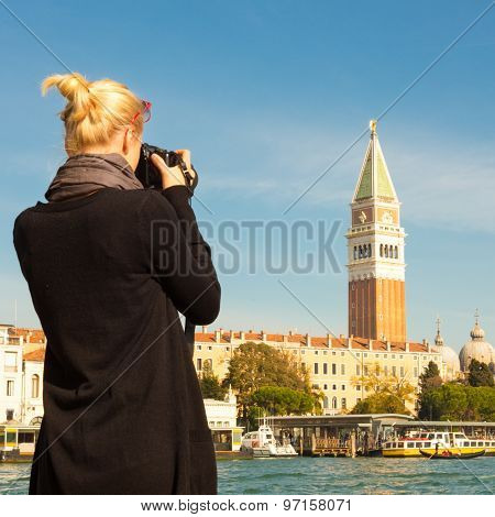 Female tourist taking photo of Venice.