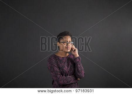 African Woman With Hand On Chin Thinking On Blackboard Background