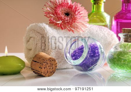 Oils And Bath Salts On White Glass Table Close-up Front