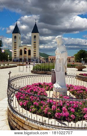 Medjugorje, Bosnia and Herzegovina - June 17, 2012: Saint James church and statue of Holy Mary - Our Lady of Medjugorje, this is the place where it is believed that Blessed Virgin Marry appeared.