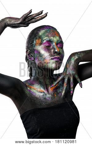 Young artistic woman in black paint and colourful powder. Glowing dark makeup. Creative body art on the theme of space and stars. Bodypainting project: art, beauty, fashion