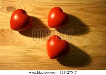 Three red heart and and their shadows