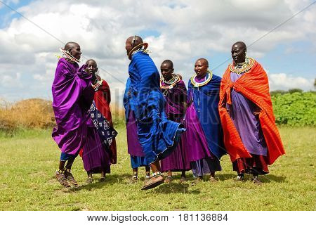 Africa Tanzania - Fеbruary 2016: Masai women in colorful clothes perform a ritual dance in a traditional village