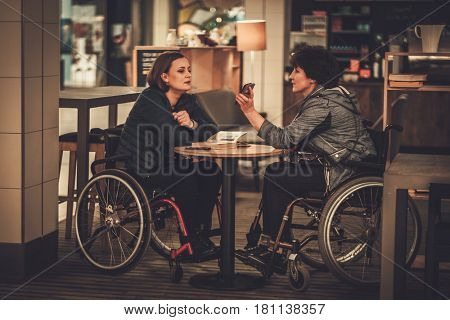 Two physically challenged women in a cafe