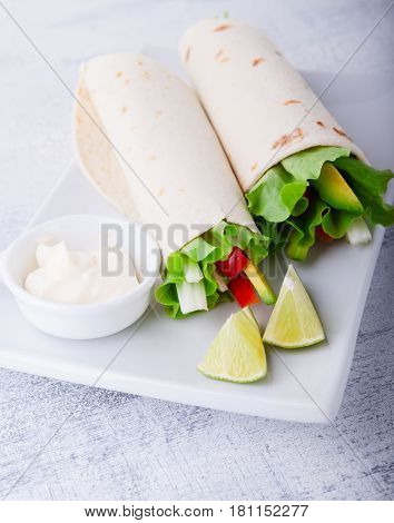Vegetable wrap sandwiches with greenery and tomatoes