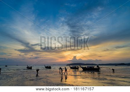 People on the Ao Nang beach at sunset in Krabi province Thailand