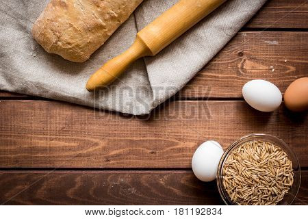 bakery concept with homemade fresh wheat bread on rustic kitchen table background top view moke-up