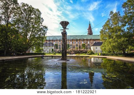Royal Library Gardens in Copenhagen, Denmark. Beautiful park in the center of the city with a eight-meter-high water sculpture made by copper in center of a pond