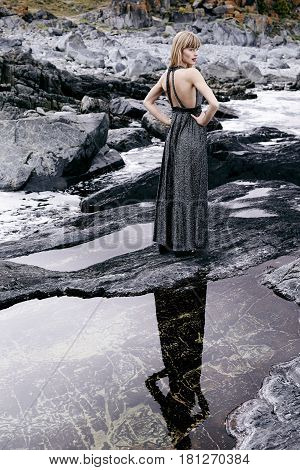 Blond and beautiful woman in rocky landscape