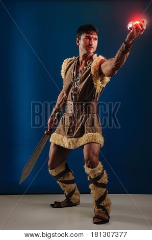 The brave caveman is holding up a light.