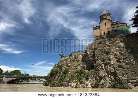 Norashen Church and a monument to King Vakhtang against the background of Metekhi Bridge, Tbilisi, Georgia